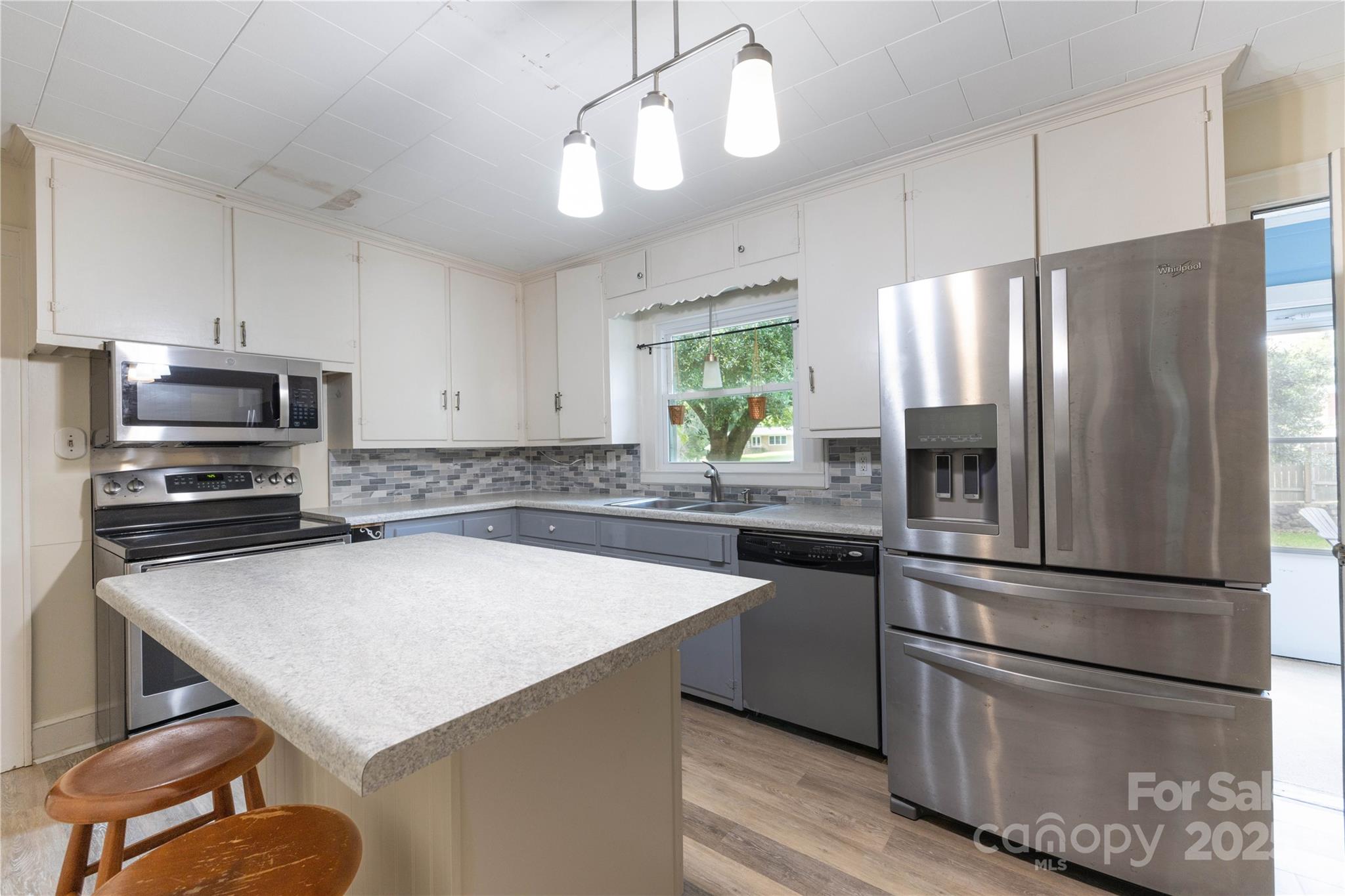 80 Pine Street Badin, NC 28009 - Photo 14 of 42 a kitchen with kitchen island a counter appliances and cabinets