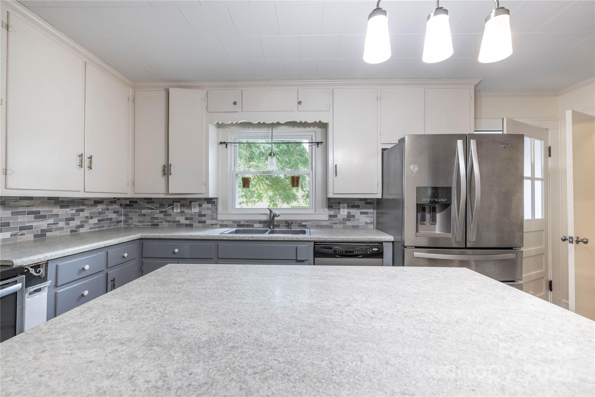 80 Pine Street Badin, NC 28009 - Photo 15 of 42 a kitchen with kitchen island granite countertop a stove a refrigerator a sink and dishwasher
