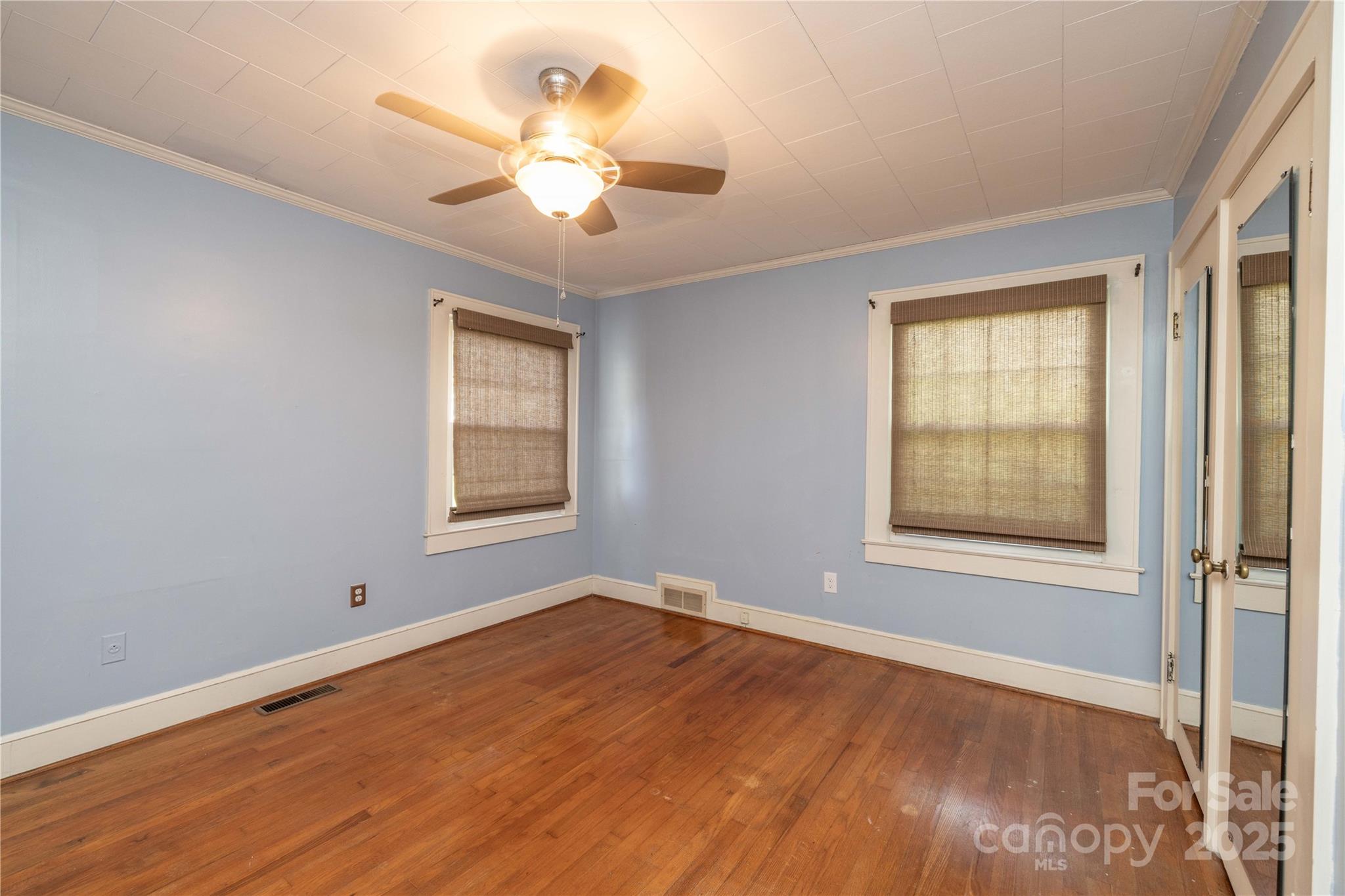 80 Pine Street Badin, NC 28009 - Photo 17 of 42 a view of an empty room with a window and wooden floor