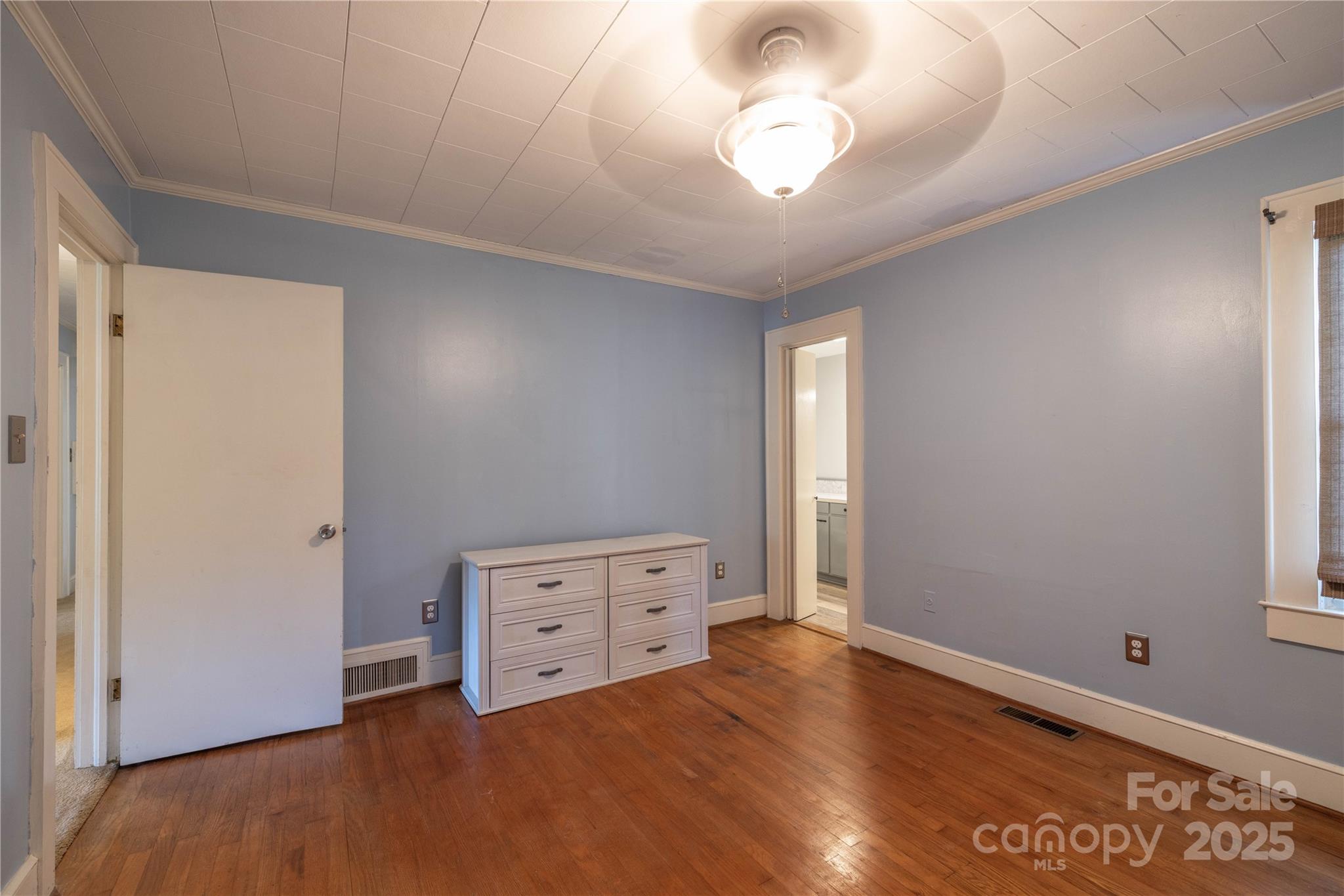 80 Pine Street Badin, NC 28009 - Photo 19 of 42 a view of an empty room with a window and wooden floor