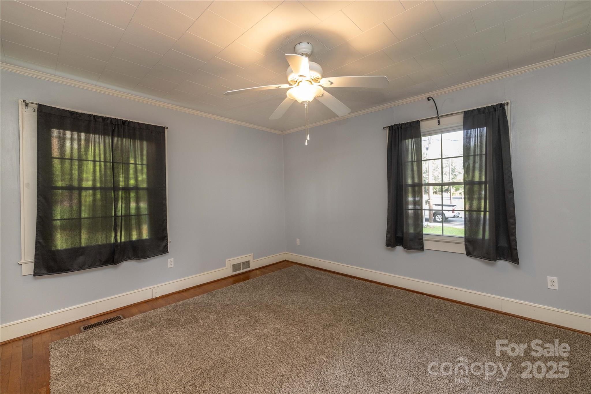 80 Pine Street Badin, NC 28009 - Photo 22 of 42 an empty room with chandelier fan and windows