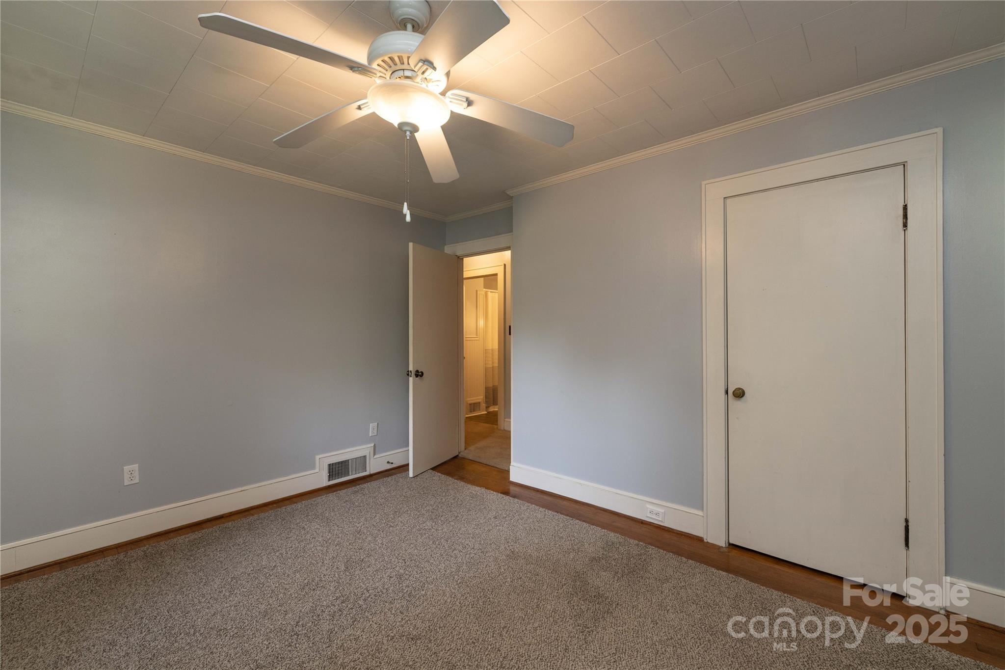 80 Pine Street Badin, NC 28009 - Photo 23 of 42 an empty room with a ceiling fan and a window