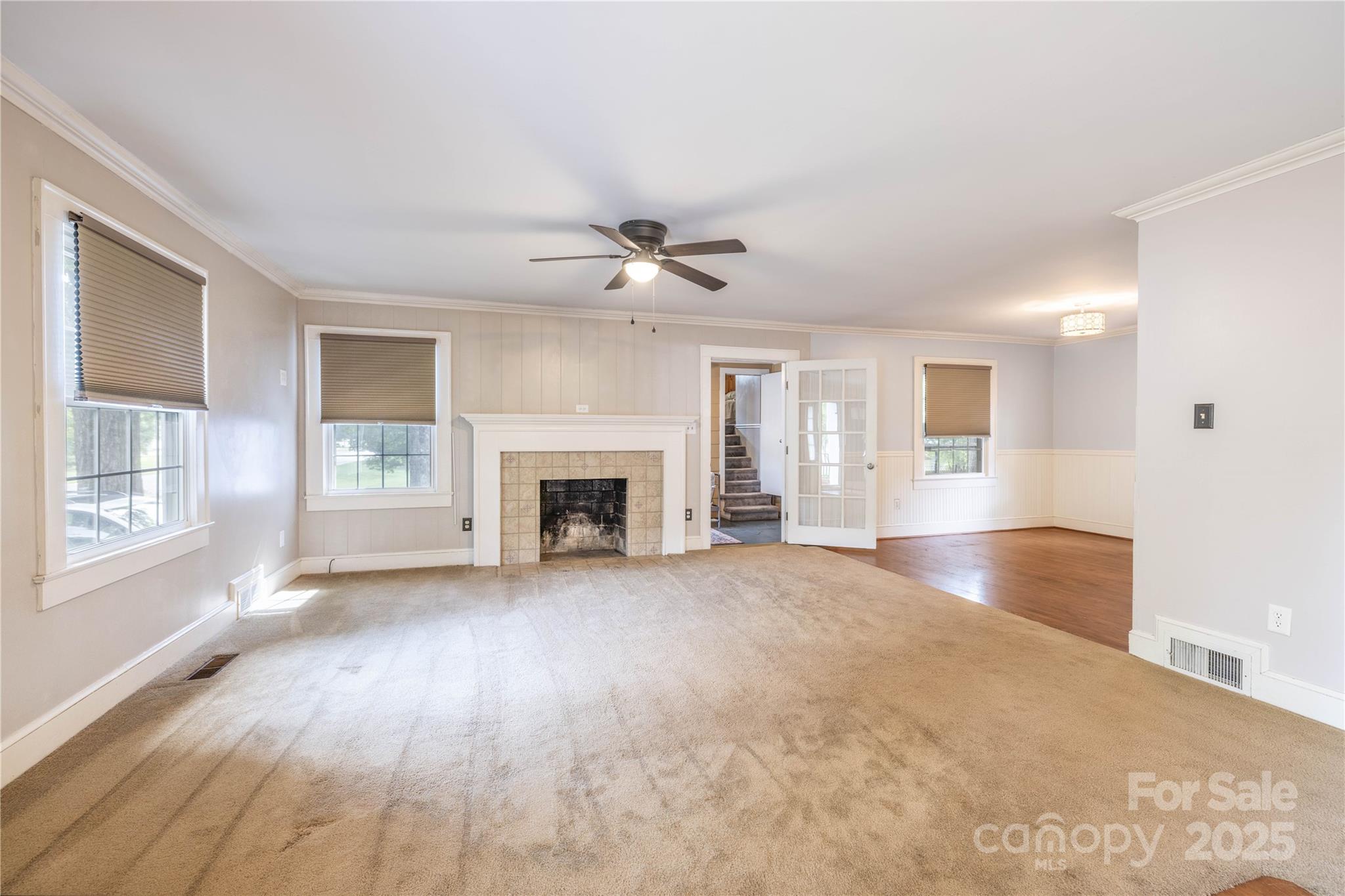 80 Pine Street Badin, NC 28009 - Photo 7 of 42 an empty room with windows and fireplace