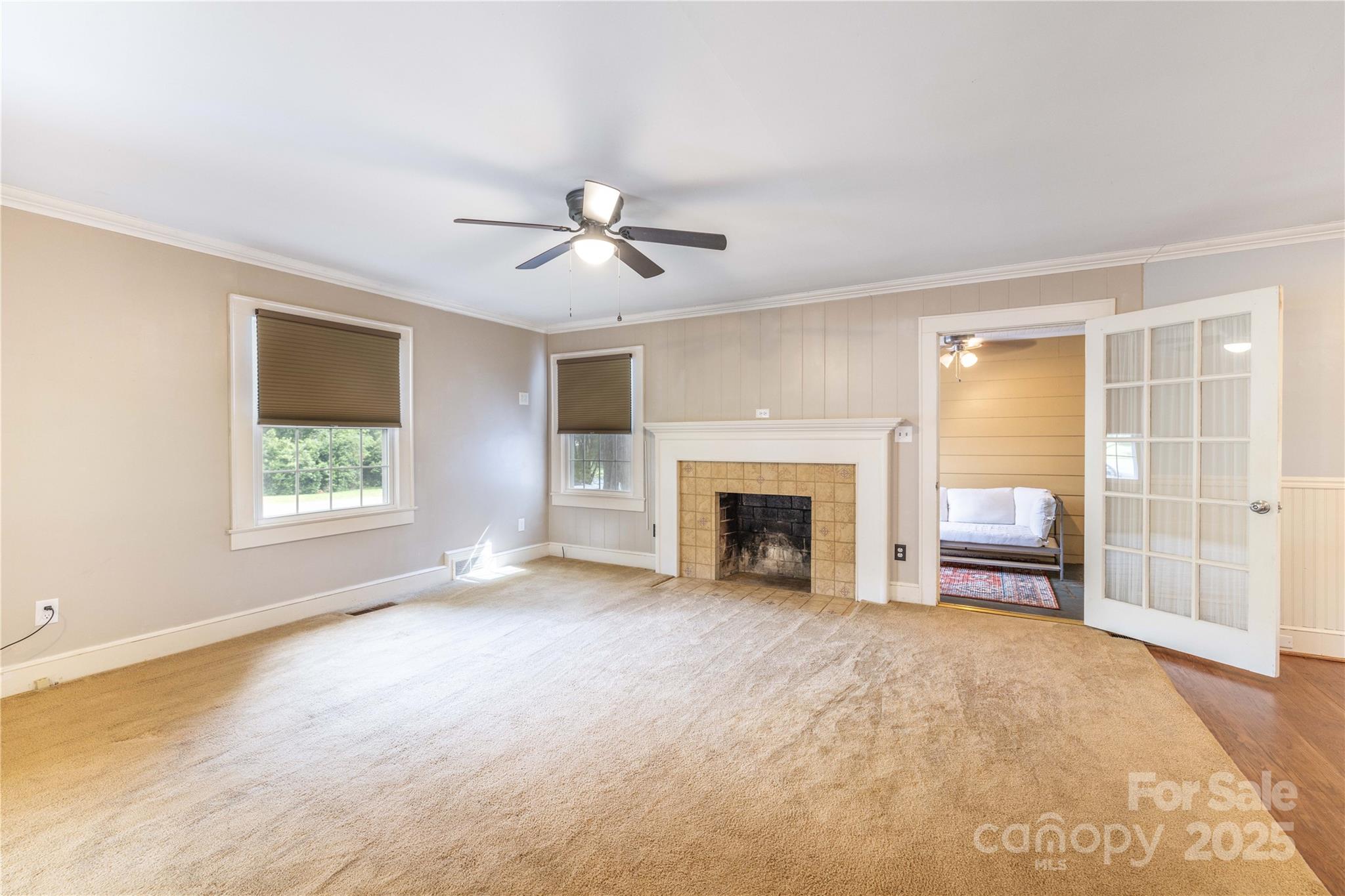 80 Pine Street Badin, NC 28009 - Photo 8 of 42 a view of an empty room with a fireplace and a window