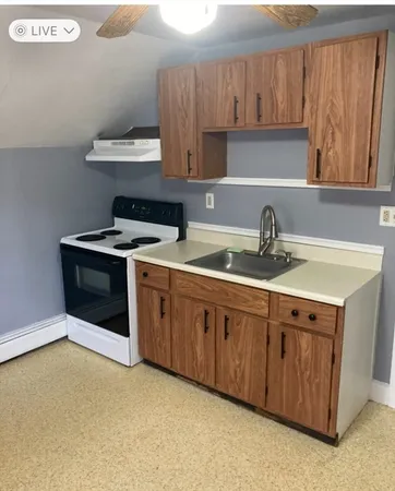 a kitchen with stainless steel appliances granite countertop a sink a stove and a refrigerator
