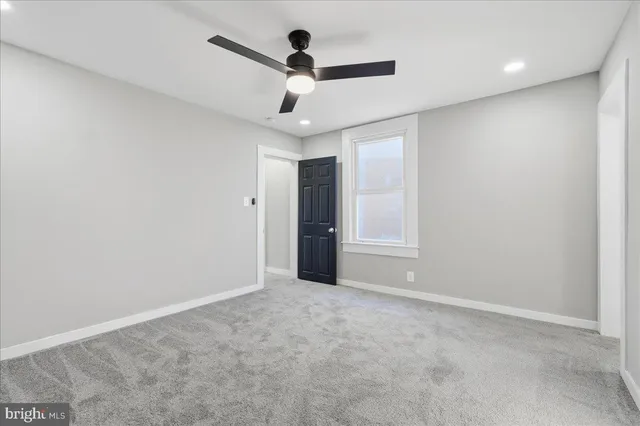 a view of an empty room with a ceiling fan