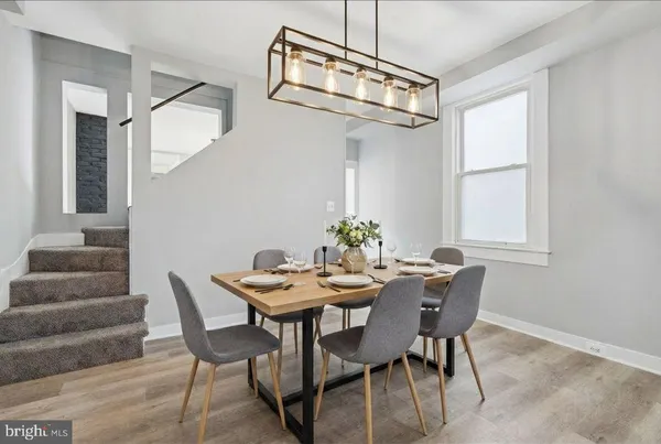 a view of a dining room with furniture and a chandelier