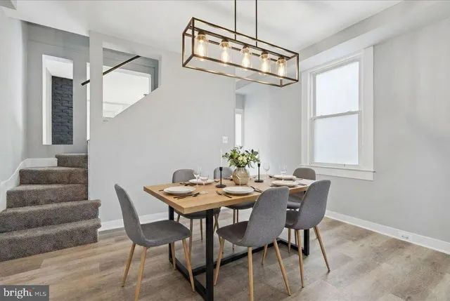 a view of a dining room with furniture and a chandelier