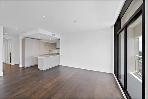 a view of a kitchen with a sink and a refrigerator