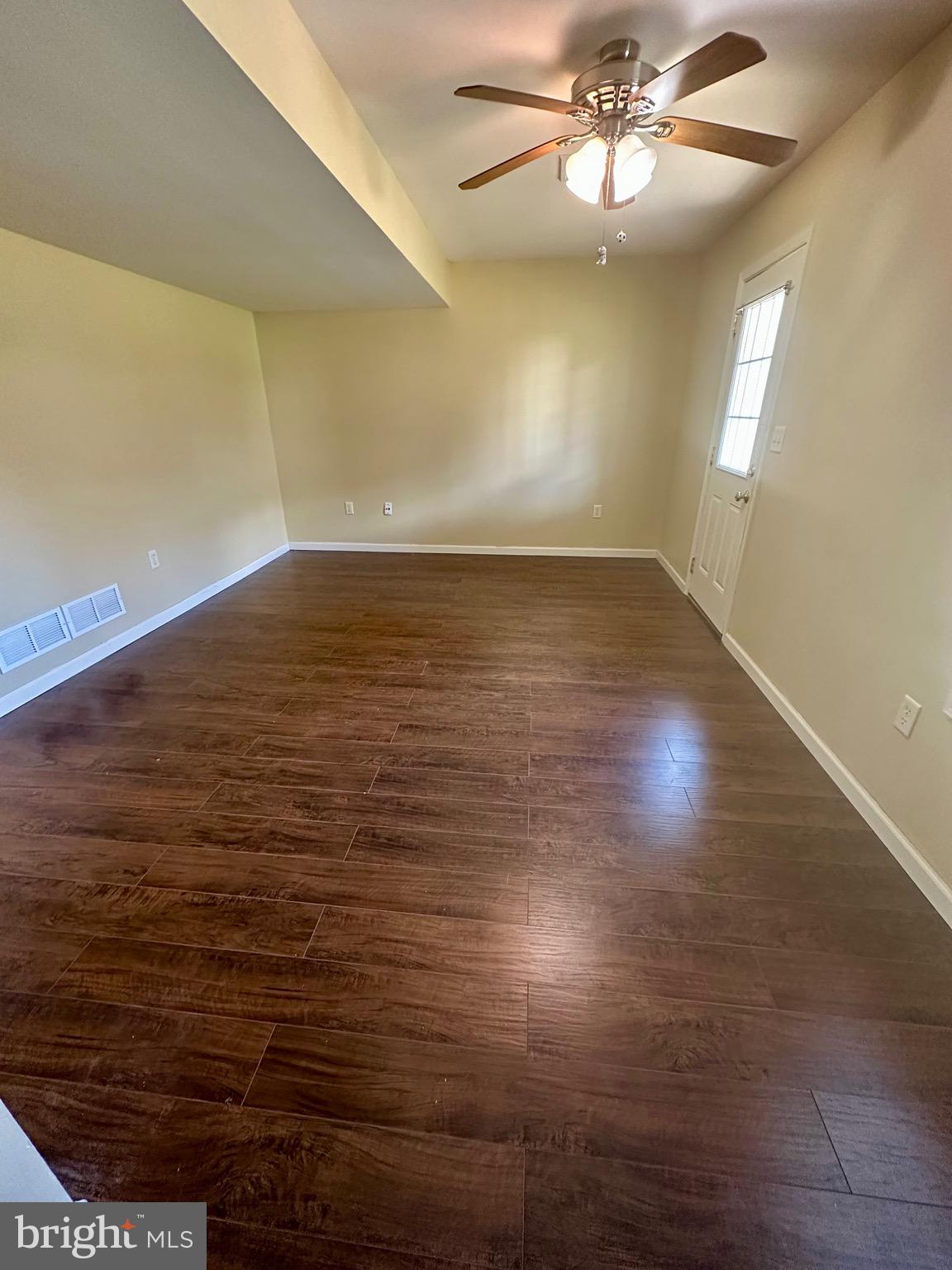 184 Mapleton Drive Harrisburg, PA 17112 - Photo 29 of 37 an empty room with wooden floor and windows
