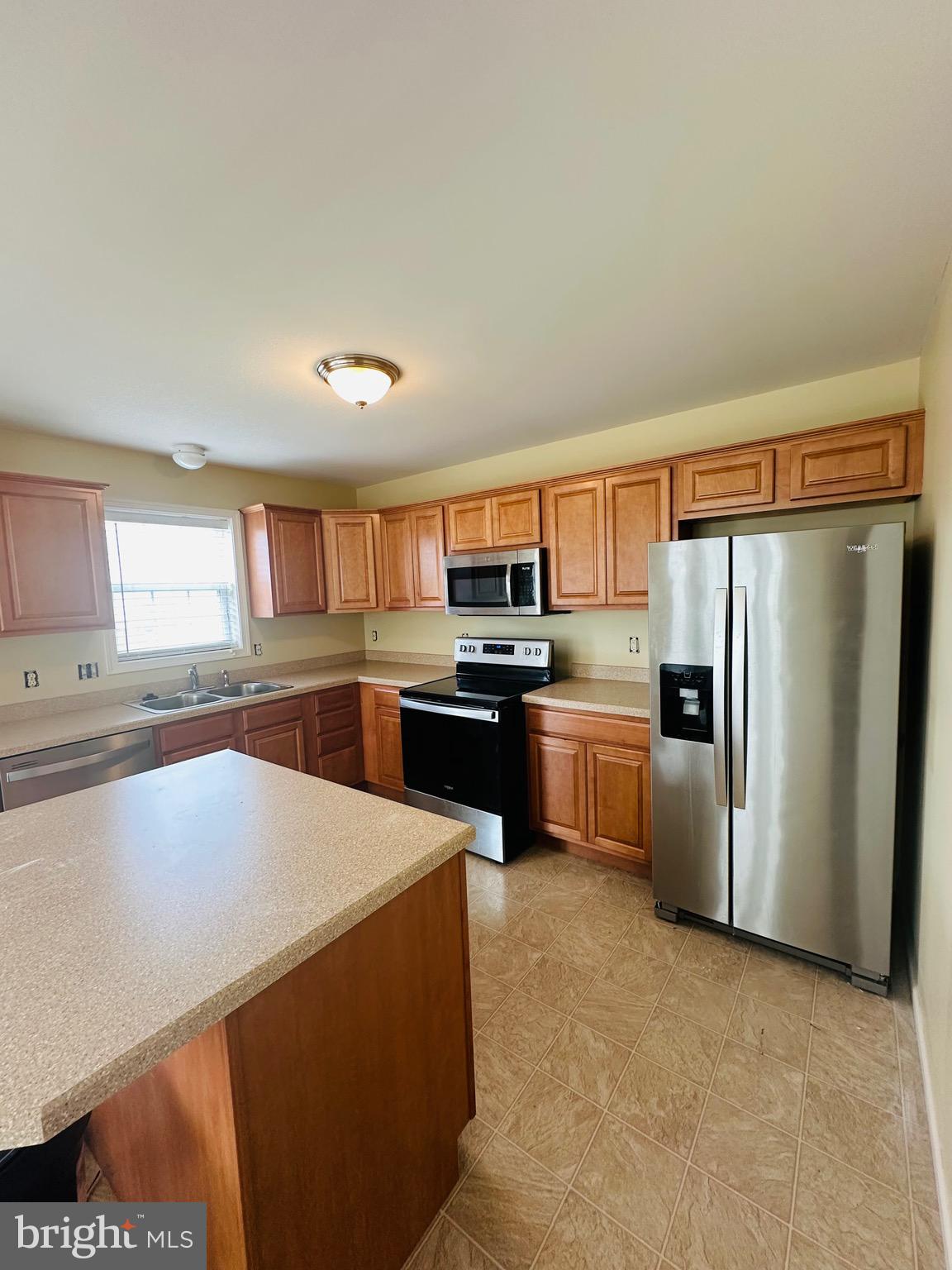 184 Mapleton Drive Harrisburg, PA 17112 - Photo 9 of 37 a kitchen with stainless steel appliances a refrigerator a stove a sink dishwasher a oven with white cabinets and wooden floor