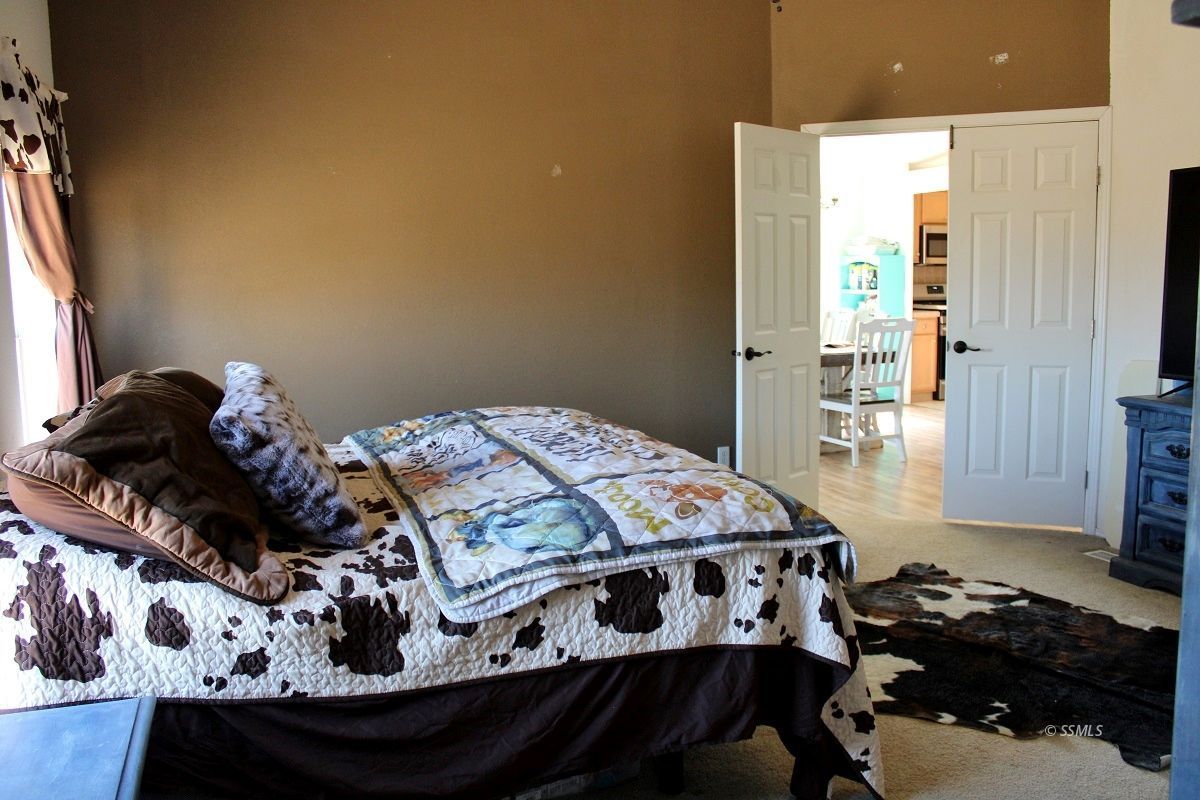 10158 Hillview Acres Road Weldon, CA 93283 - Photo 26 of 45 a bedroom with a bed and a chandelier