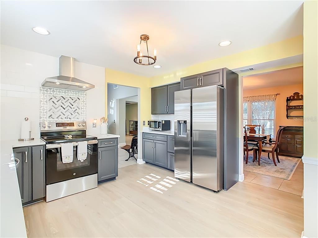 2901 Plantation Road Winter Haven, FL 33884 - Photo 11 of 30 a kitchen with stainless steel appliances a stove a refrigerator and a sink