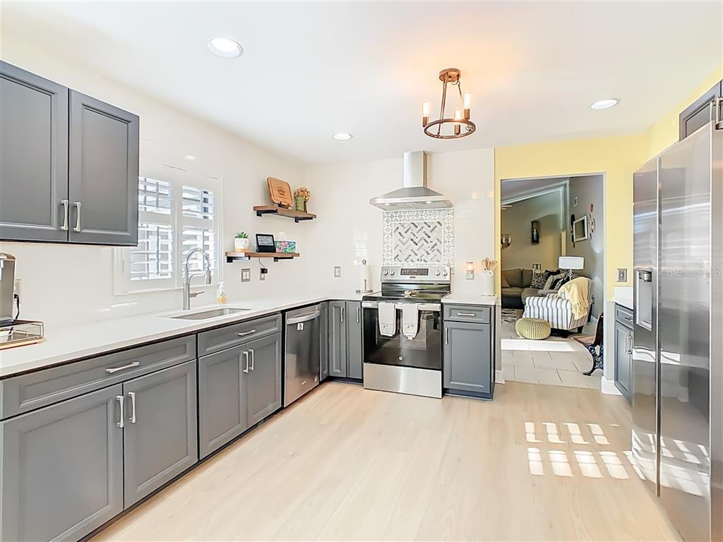 2901 Plantation Road Winter Haven, FL 33884 - Photo 12 of 30 a kitchen with sink cabinets and window