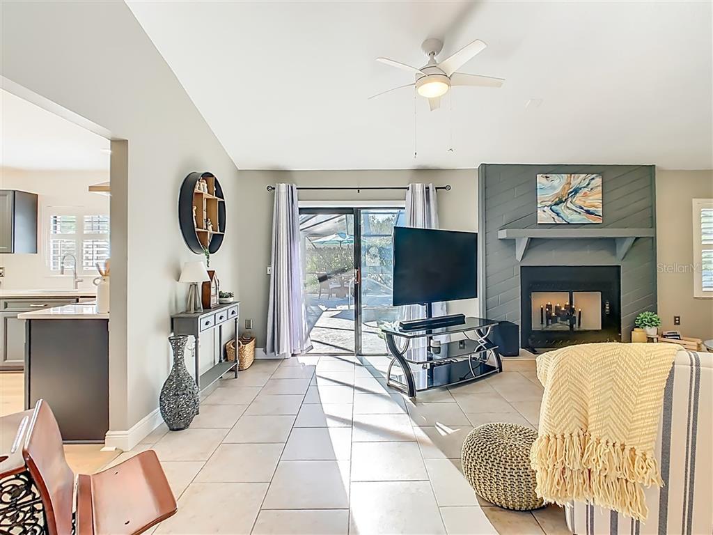 2901 Plantation Road Winter Haven, FL 33884 - Photo 14 of 30 a living room with furniture a flat screen tv and a fireplace
