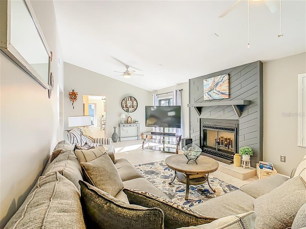 2901 Plantation Road Winter Haven, FL 33884 - Photo 16 of 30 a living room with furniture and a fireplace