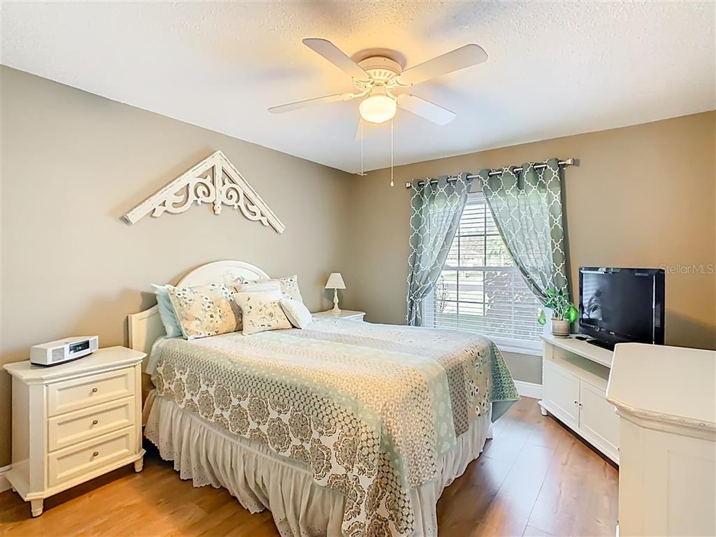 2901 Plantation Road Winter Haven, FL 33884 - Photo 21 of 30 a bedroom with a bed and a chandelier