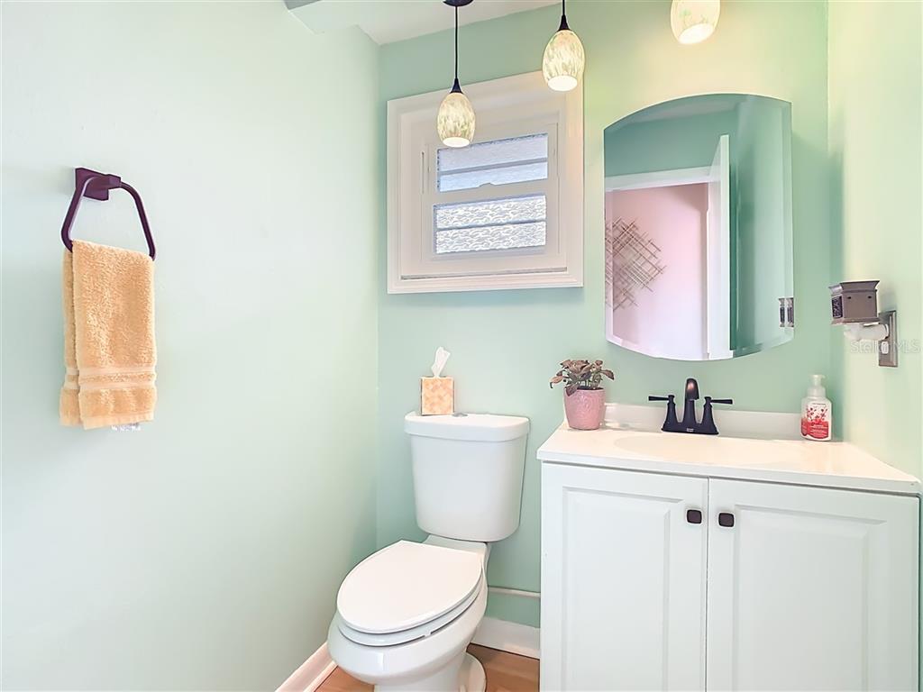 2901 Plantation Road Winter Haven, FL 33884 - Photo 23 of 30 a bathroom with a sink vanity mirror and toilet
