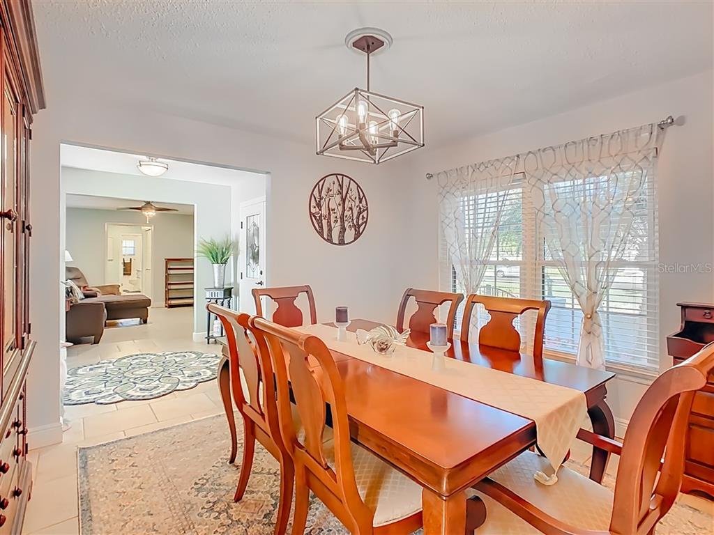 2901 Plantation Road Winter Haven, FL 33884 - Photo 8 of 30 a view of a dining room and livingroom furniture wooden floor and a chandelier