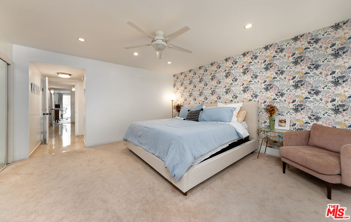 4350 Vía Dolce, Unit 105 Marina del Rey, CA 90292 - Photo 14 of 31 a spacious bedroom with a bed and ceiling fan