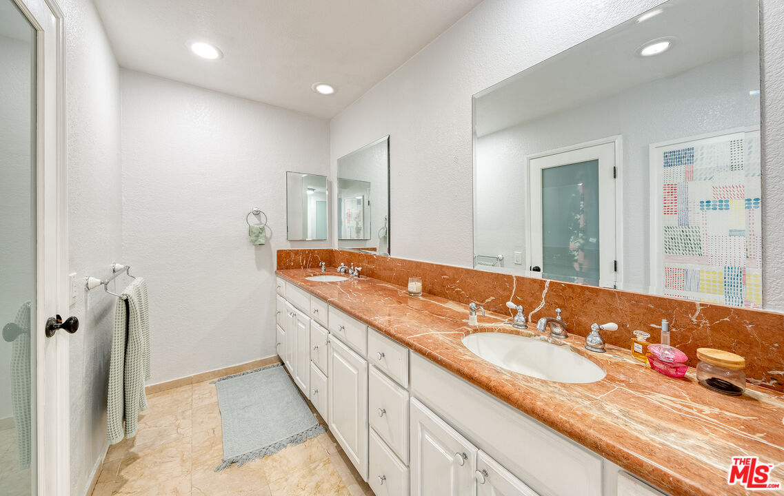 4350 Vía Dolce, Unit 105 Marina del Rey, CA 90292 - Photo 15 of 31 a bathroom with a sink and a mirror