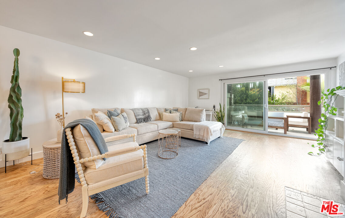 4350 Vía Dolce, Unit 105 Marina del Rey, CA 90292 - Photo 3 of 31 a living room with furniture and a large window