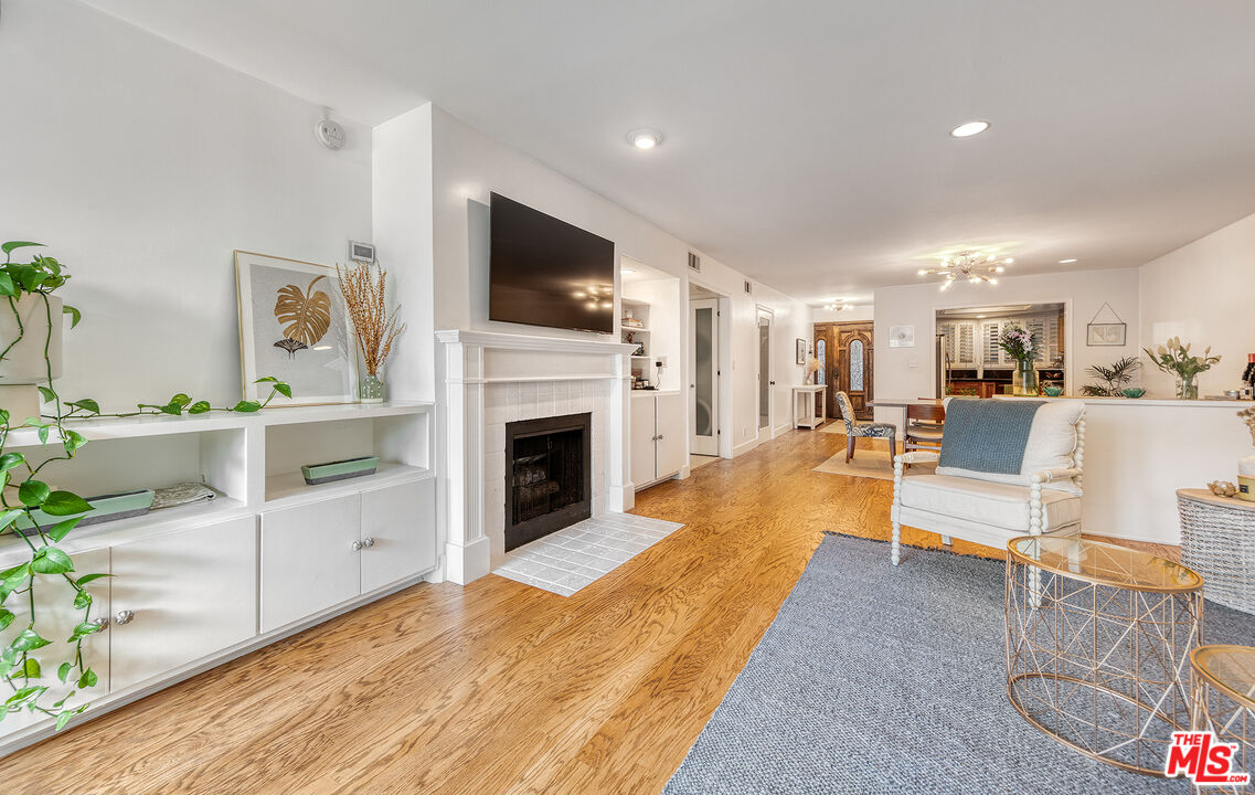 4350 Vía Dolce, Unit 105 Marina del Rey, CA 90292 - Photo 10 of 31 a living room with furniture a flat screen tv and a fireplace