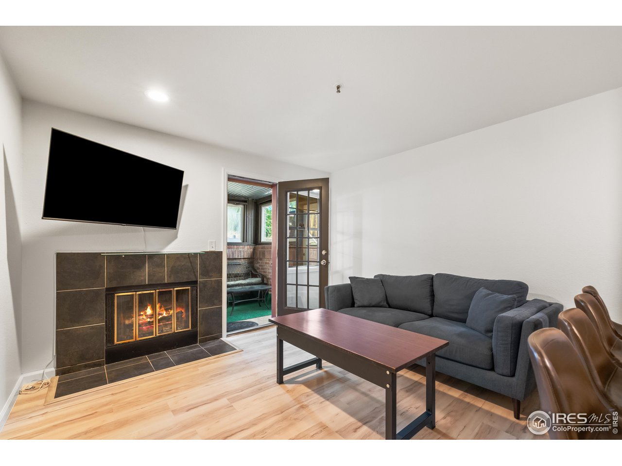 1405 Broadway, Unit 101 Boulder, CO 80302 - Photo 2 of 22 a living room with furniture a flat screen tv and a fireplace