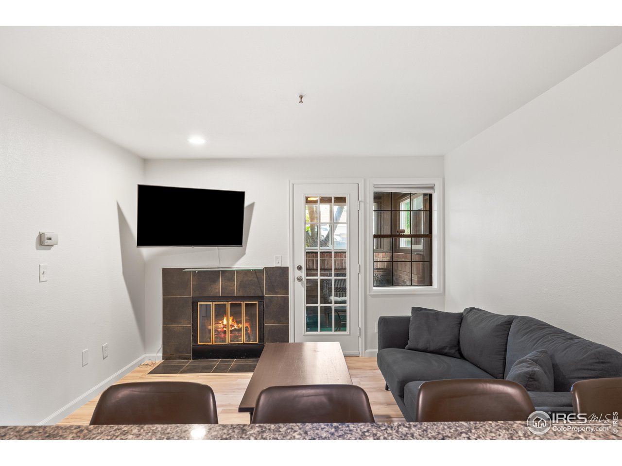 1405 Broadway, Unit 101 Boulder, CO 80302 - Photo 21 of 22 a living room with furniture and a flat screen tv
