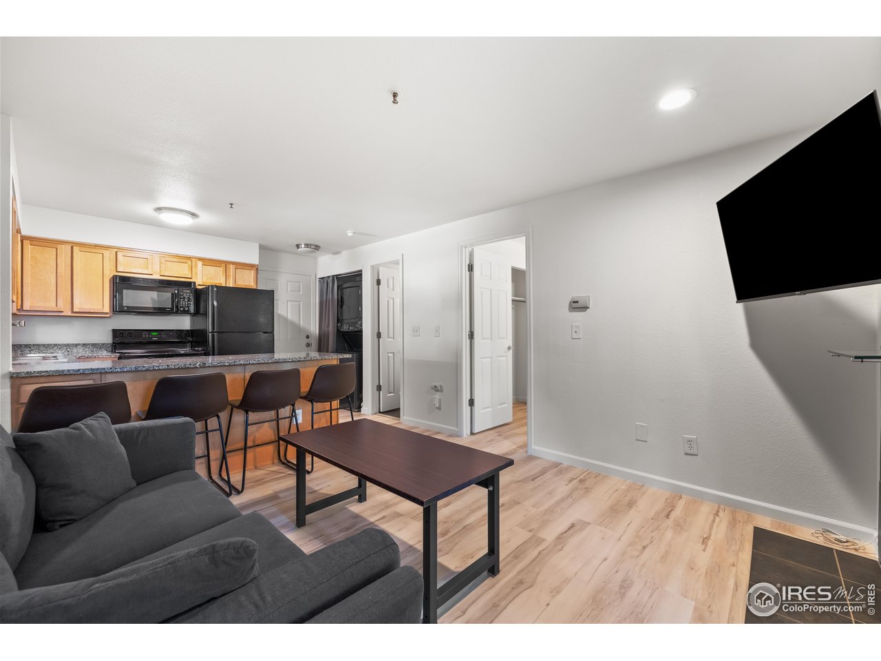 1405 Broadway, Unit 101 Boulder, CO 80302 - Photo 9 of 22 a living room with furniture and a flat screen tv