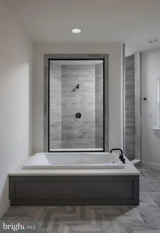 a bathroom with a bathtub and shower