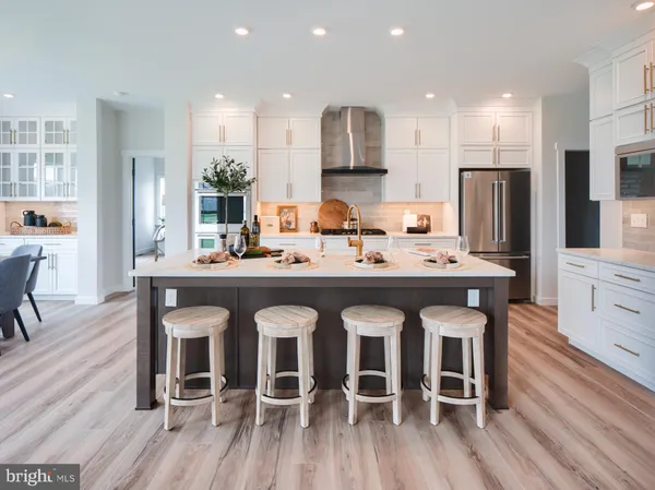 a large kitchen with a table and chairs