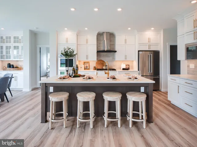 a large kitchen with a table and chairs