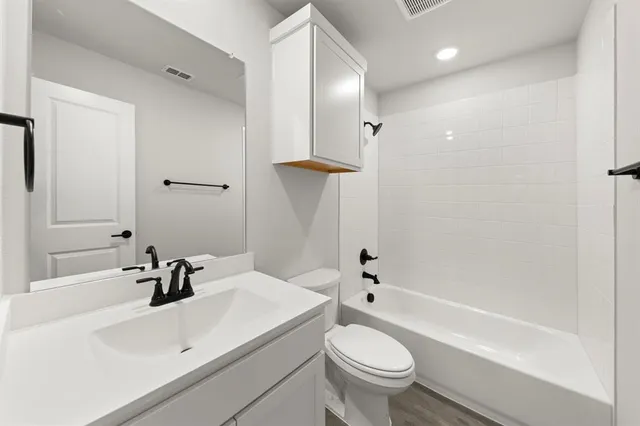 a bathroom with a sink a toilet and a bathtub