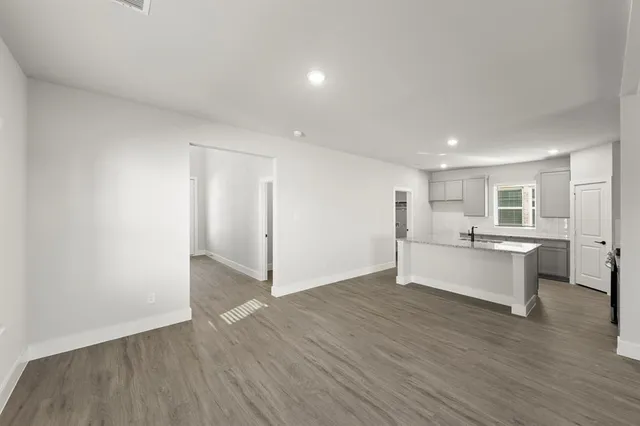 a large space with a wooden floor and window