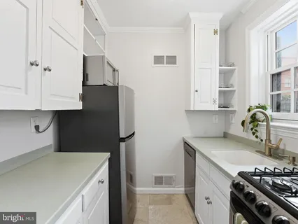 a kitchen with a sink and a stove top oven