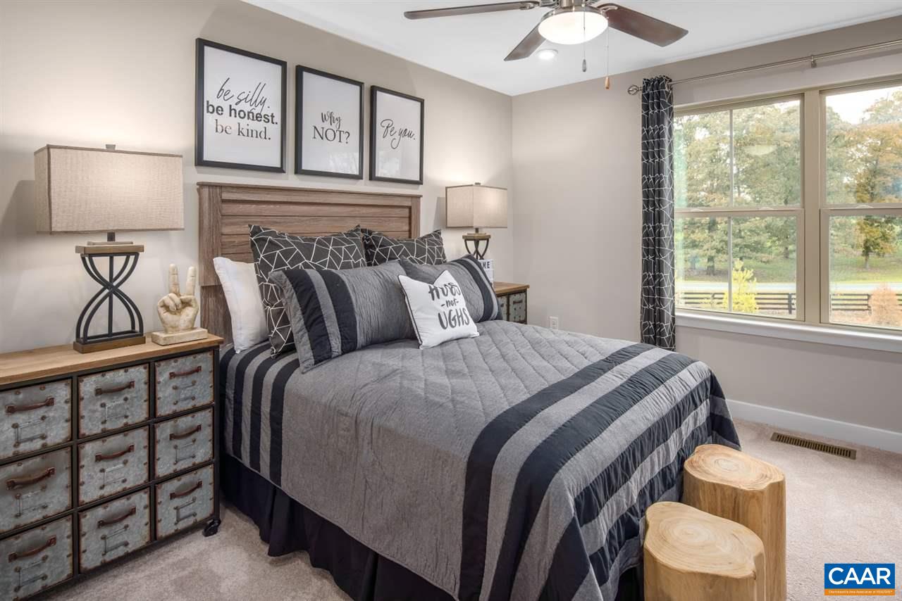 376 Winding Road Keswick, VA 22947 - Photo 23 of 24 a bedroom with a bed and a chandelier