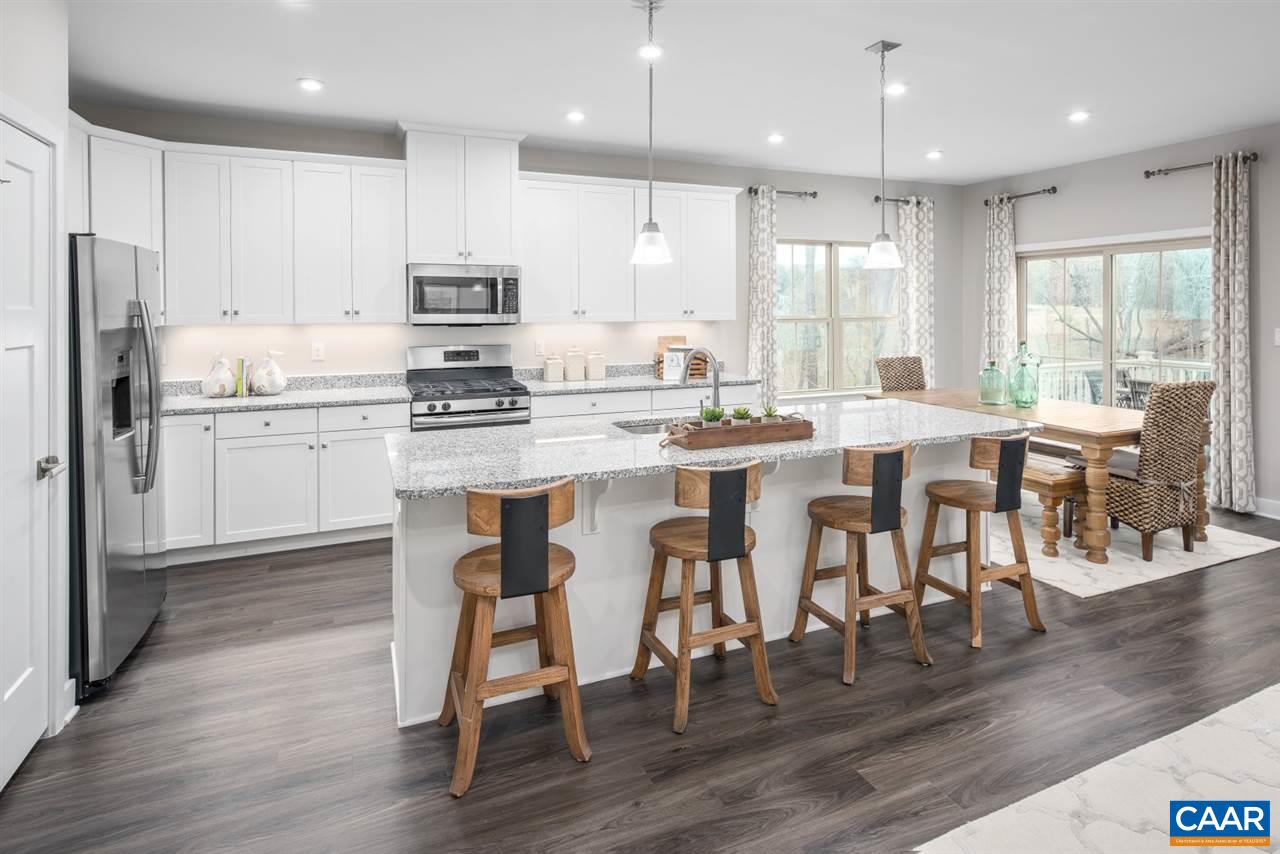376 Winding Road Keswick, VA 22947 - Photo 4 of 24 a kitchen with stainless steel appliances granite countertop a stove a sink a refrigerator and a dining table with wooden floor