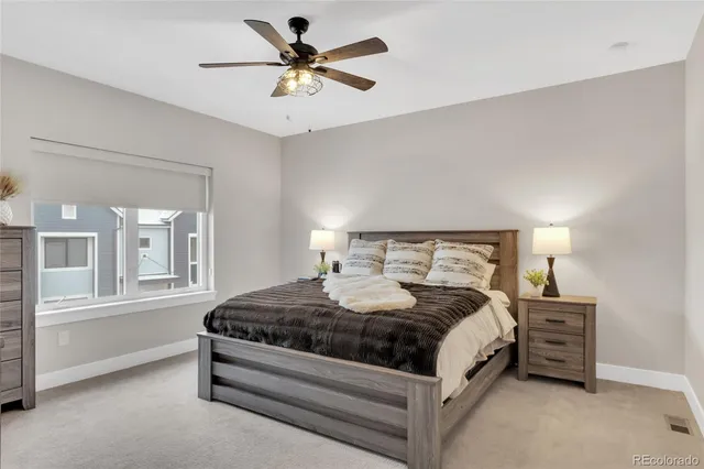 a bedroom with a bed a chandelier and a chair