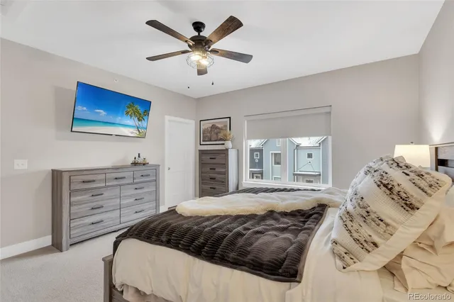 a bedroom with a bed a window and a dresser