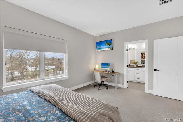 a living room with furniture a flat screen tv and a window