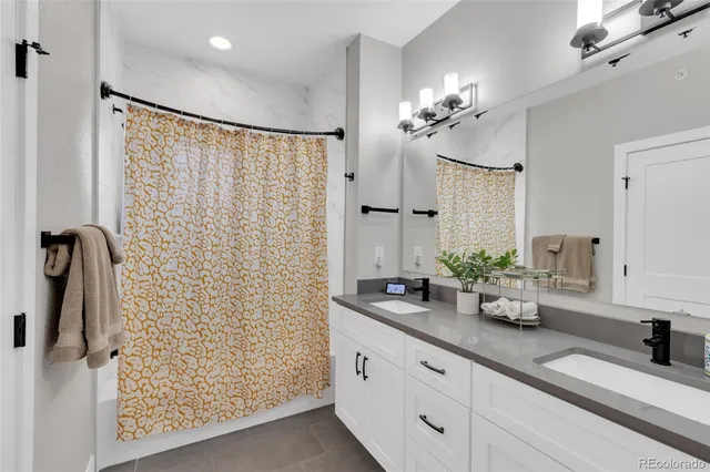 a bathroom with a double vanity sink and a mirror