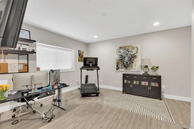 a view of a workspace with furniture and a window