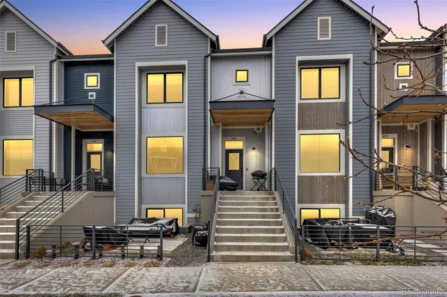 a view of a brick house with large windows