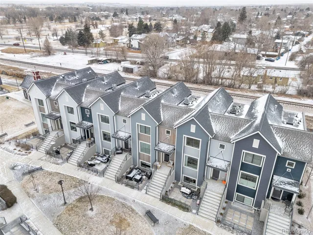 an aerial view of residential houses with yard