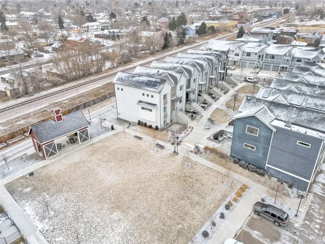 an aerial view of residential houses with outdoor space
