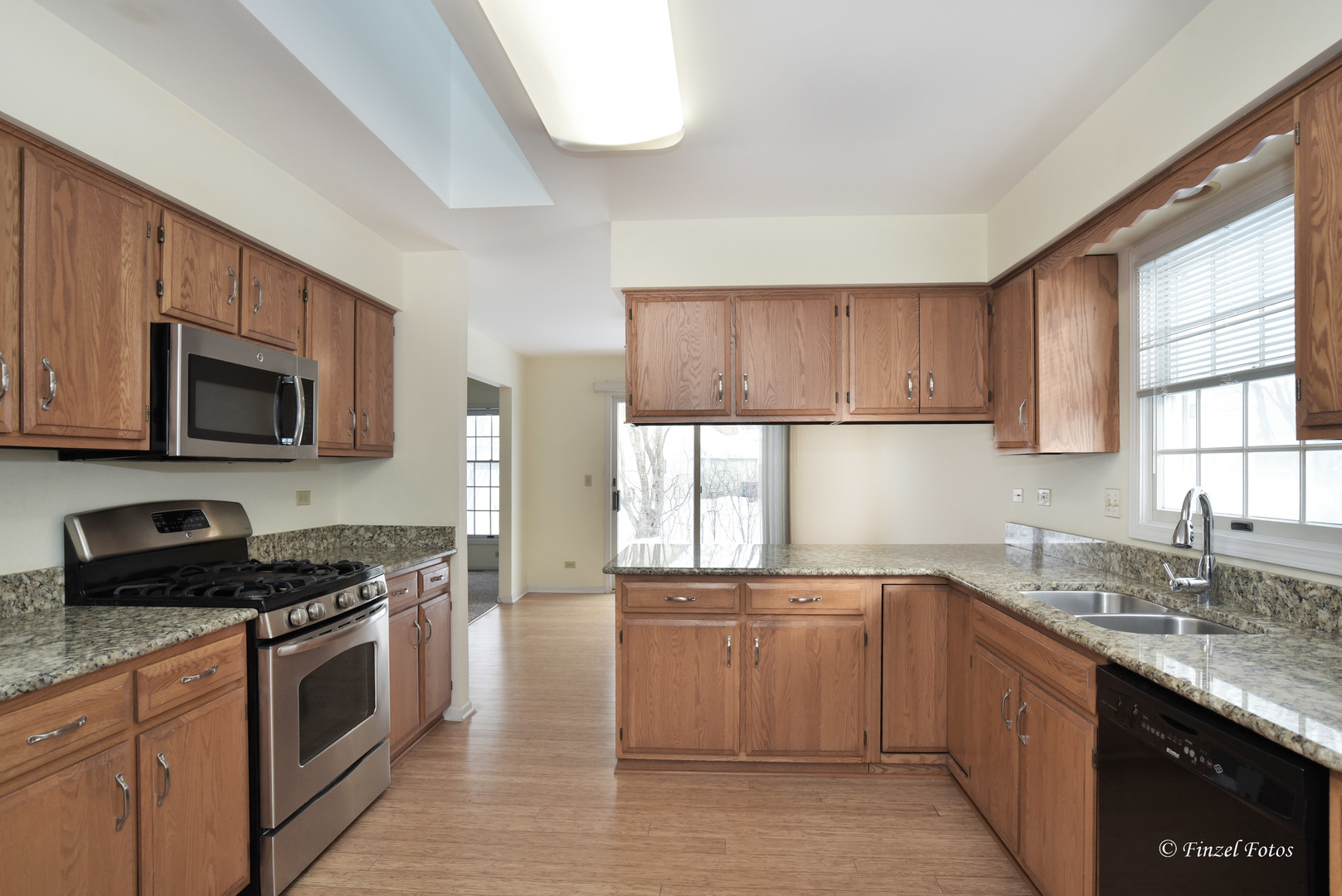 691 Canyon Lane Elgin, IL 60123 - Photo 5 of 17 a kitchen with stainless steel appliances granite countertop a stove a sink and a microwave