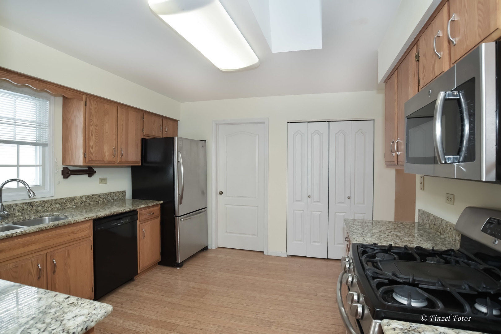 691 Canyon Lane Elgin, IL 60123 - Photo 6 of 17 a kitchen with stainless steel appliances granite countertop a stove a sink and a refrigerator