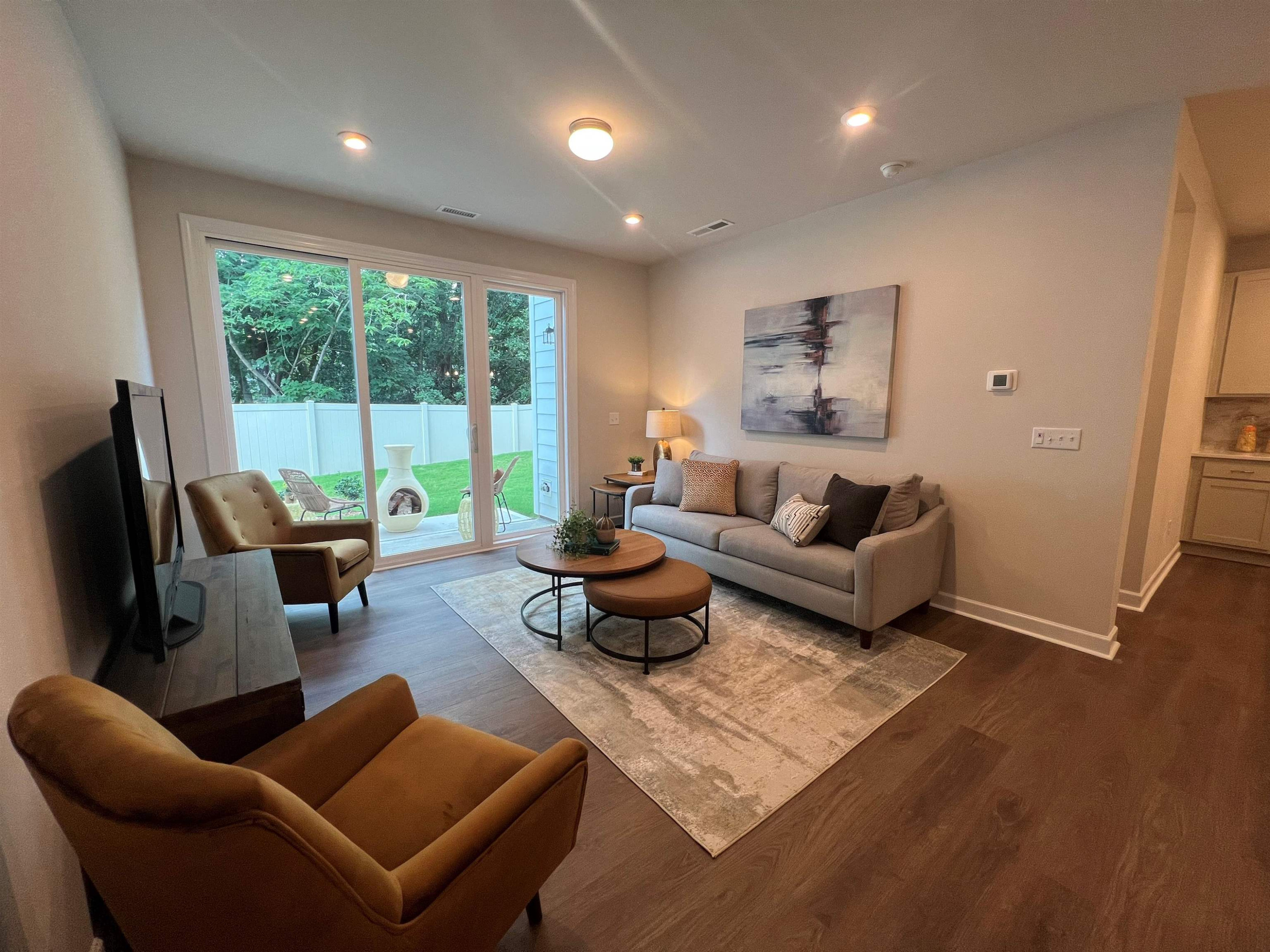 7908 Sofiana Avenue Raleigh, NC 27617 - Photo 6 of 26 a living room with furniture and a large window