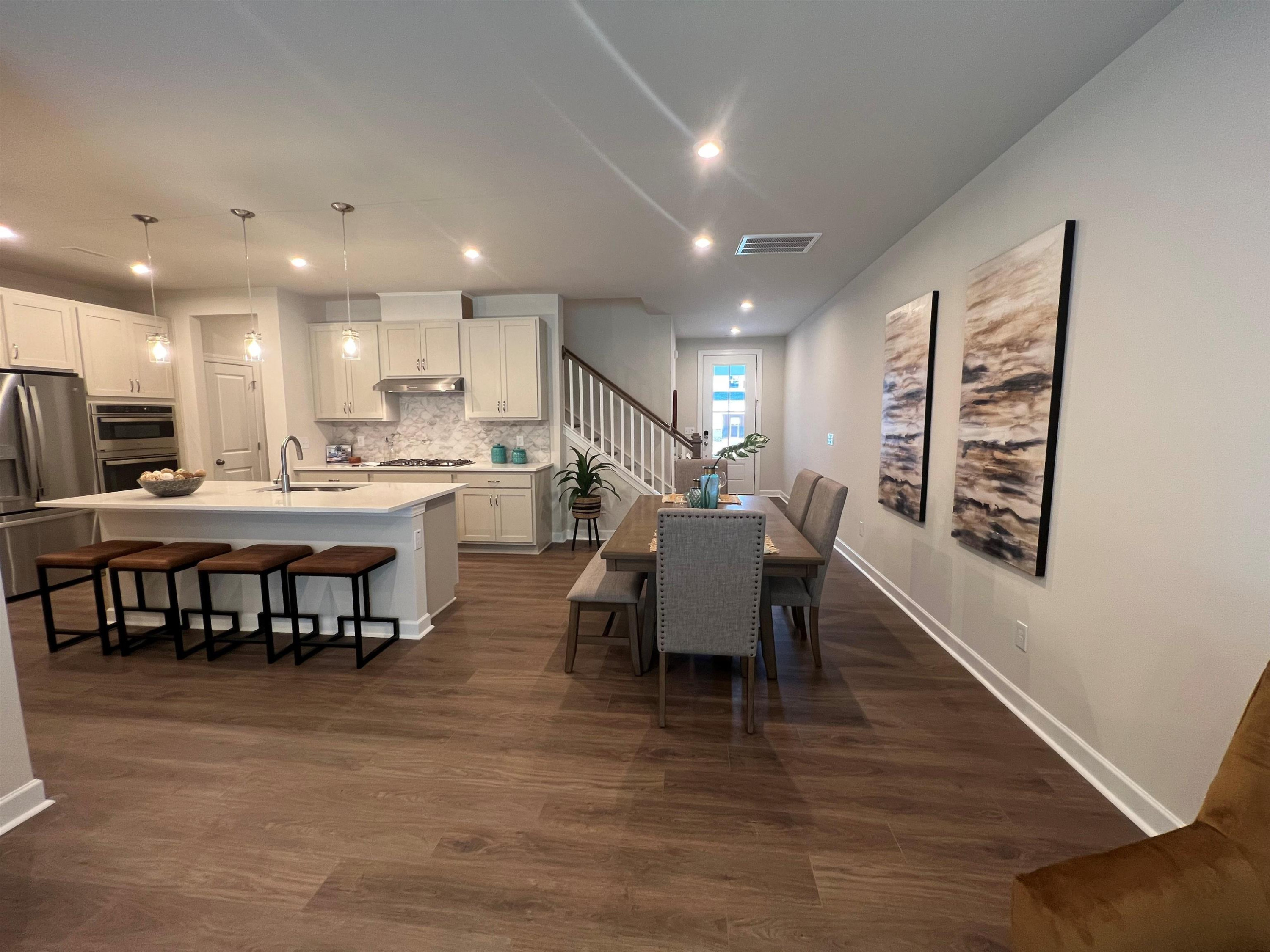 7908 Sofiana Avenue Raleigh, NC 27617 - Photo 9 of 26 a large kitchen with a table and chairs